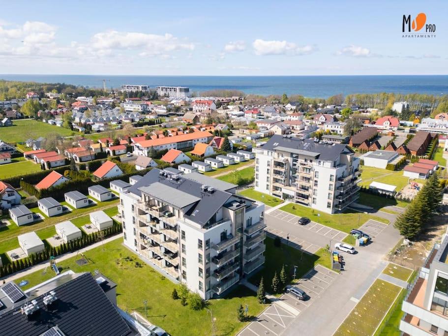 - une vue aérienne sur une ville avec des bâtiments et l'océan dans l'établissement Apartament Premium '5 Mórz', à Sianożęty