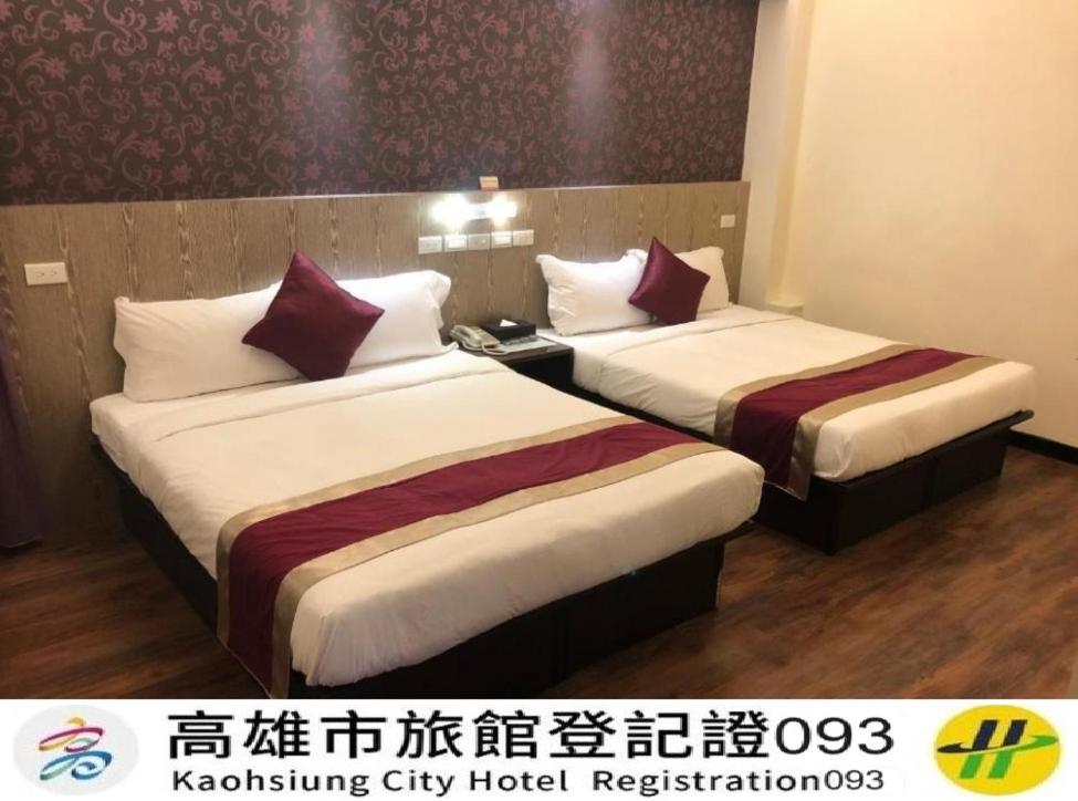 a hotel room with two beds in a room at Zhao Lai Hotel in Kaohsiung