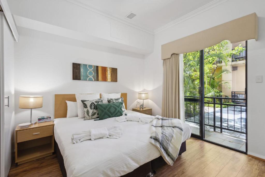 a bedroom with a large bed and a large window at 1BDR 1BTH 1PRK - James Street Joy in Perth