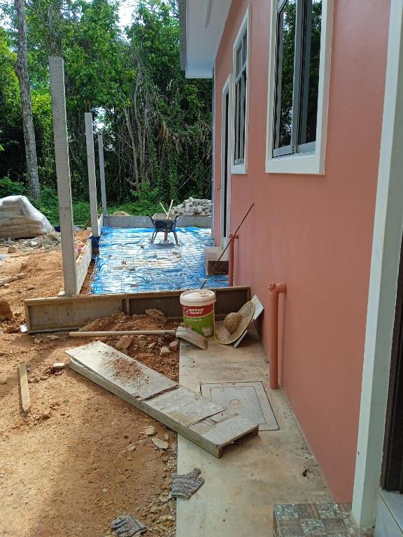 a house under construction with a dog in the yard at x da nama in Kuala Terengganu