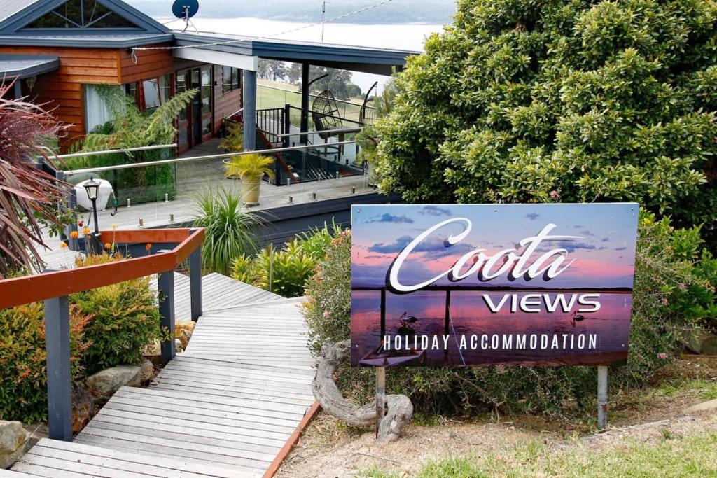 a sign in front of a house at Coota Views in Mallacoota