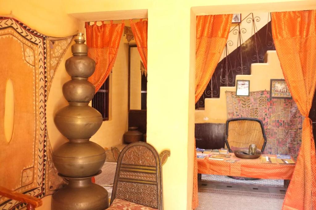 a living room with a chair and a table at Killa Bhawan Lodge in Jaisalmer