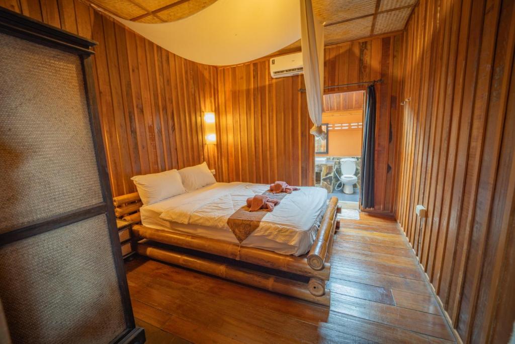 a bedroom with a bed with a teddy bear on it at JERPORDEE Residence in Ko Chang