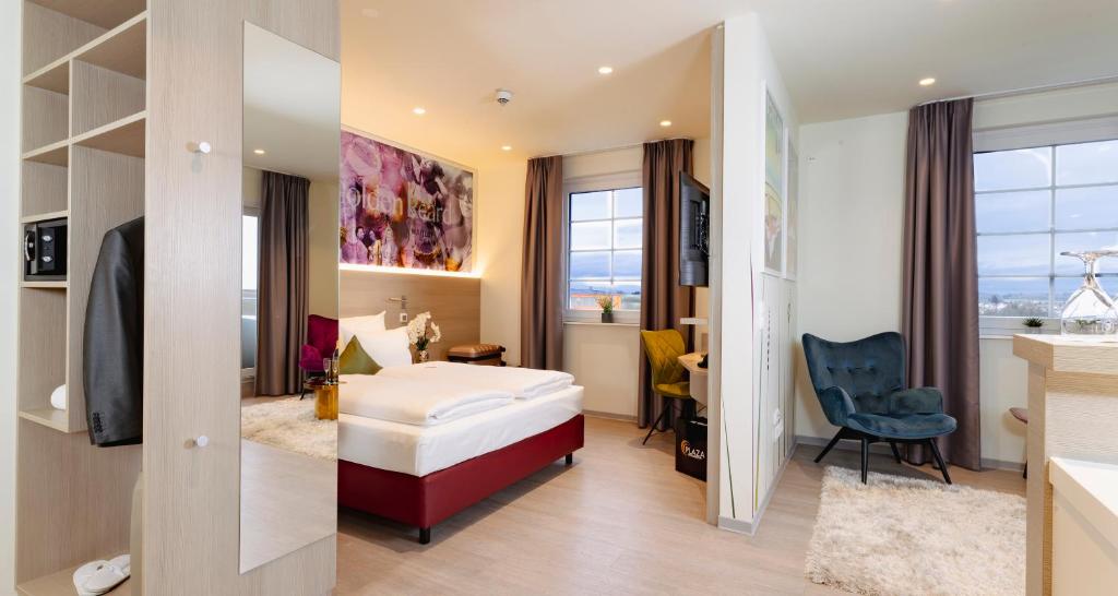 a hotel room with a bed and a desk at PLAZA INN Bad Rappenau in Bad Rappenau