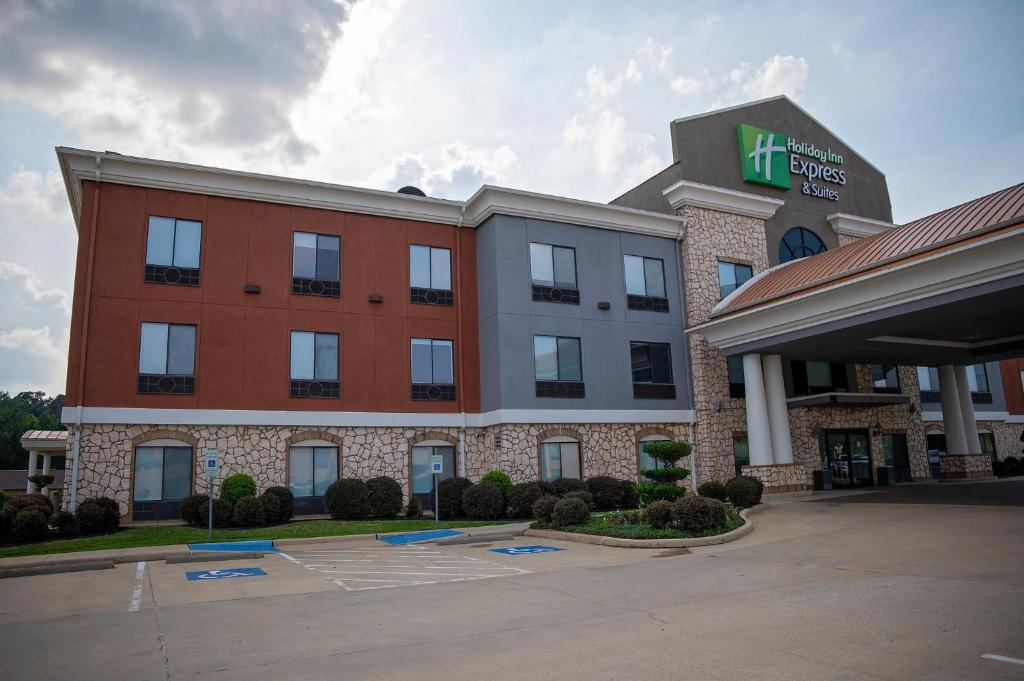 a hotel front of a building with a parking lot at Holiday Inn Express Hotel & Suites Center, an IHG Hotel in Center