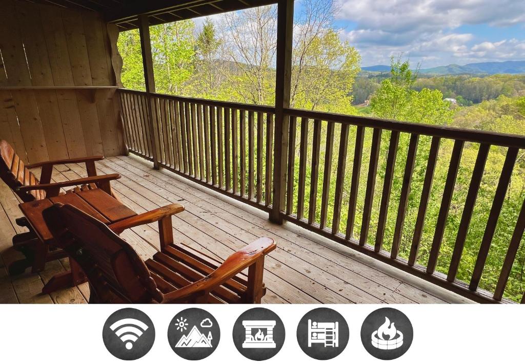 a porch with two chairs and a view of the mountains at Dolly's # 2 condo in Sevierville