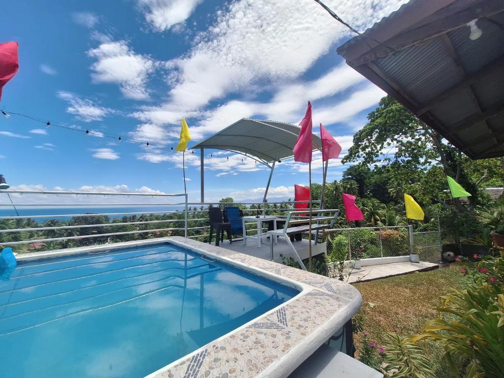 a swimming pool with a view of the ocean at Island samal overlooking view house with swimming pools in San Antonio