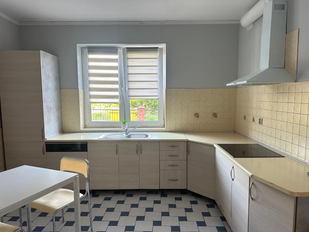 a kitchen with a sink and a window at HGS Home Noclegi PARKING in Gorzów Wielkopolski