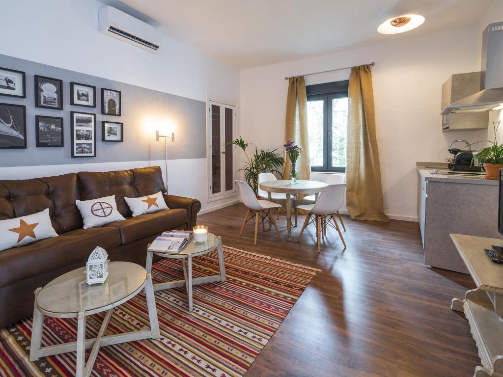 a living room filled with furniture and a fireplace at Apartamentos Los Venerables in Seville