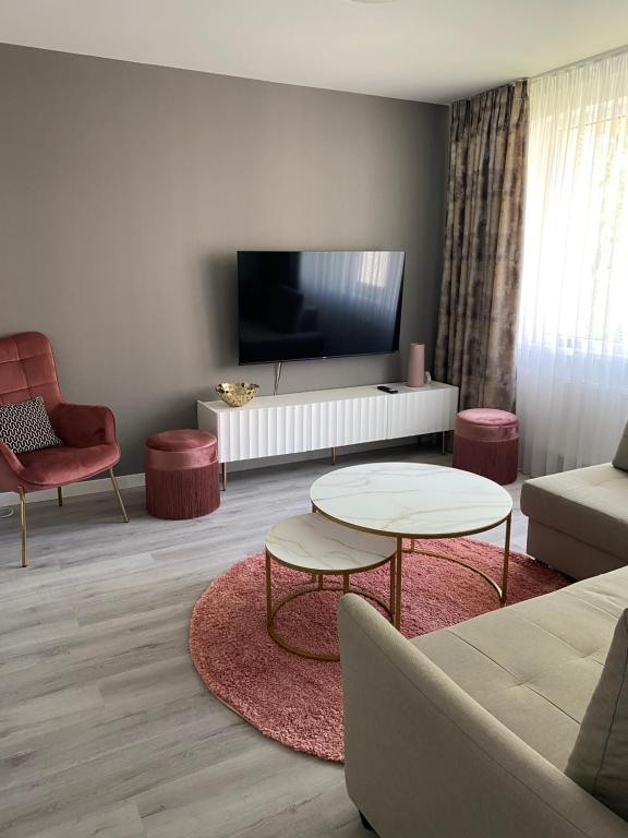 a living room with a couch and a table at Marijos apartamentai in Birštonas