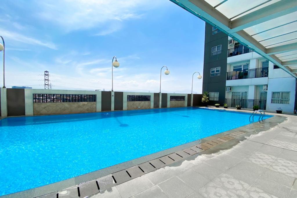 una piscina en la azotea de un edificio en OYO 93940 Apartemen Mekarwangi Square By Lina en Bandung