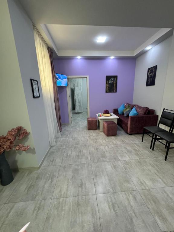 a living room with purple walls and a couch at Relaxing interior with the Best Service Self Check In in Yerevan