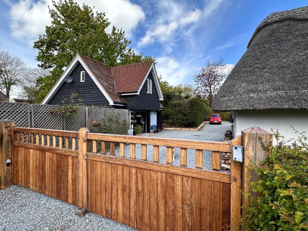 a wooden fence in front of a house at The Cottage get away in Saffron Walden