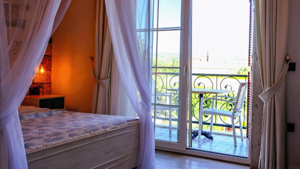 Postel nebo postele na pokoji v ubytování CASA RUBİNO BUTİK OTEL