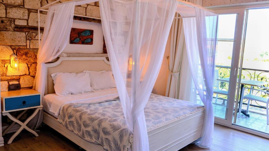 Postel nebo postele na pokoji v ubytování CASA RUBİNO BUTİK OTEL