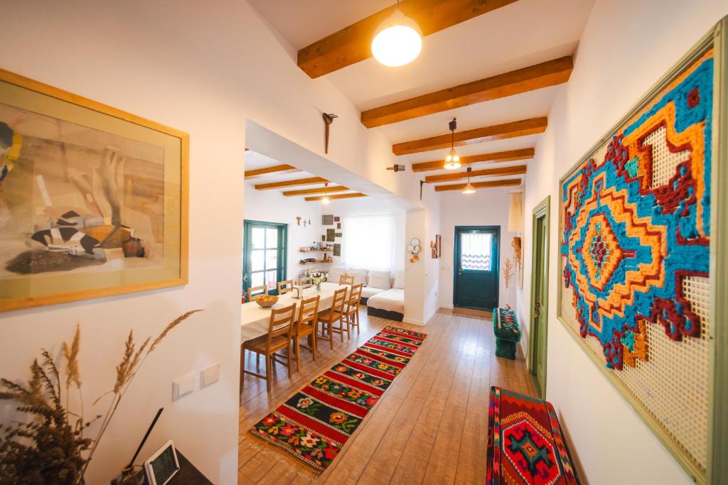a dining room and living room with a large painting on the wall at CASA LILA in Colţi