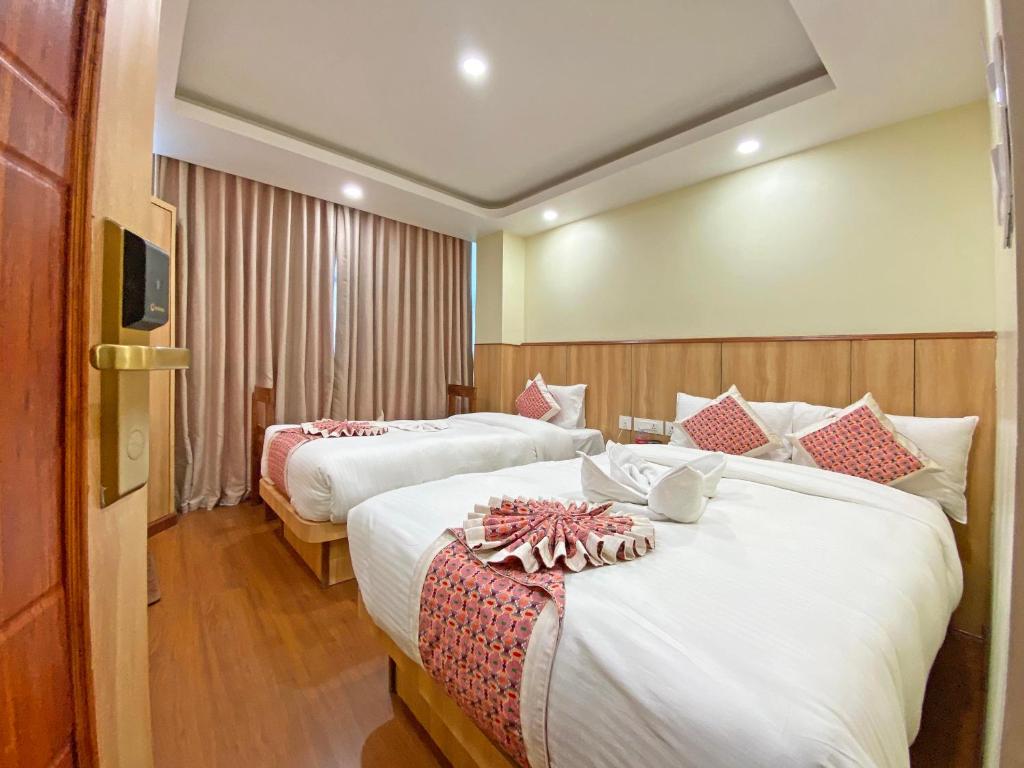 Postel nebo postele na pokoji v ubytování Hotel Lumbini Airport