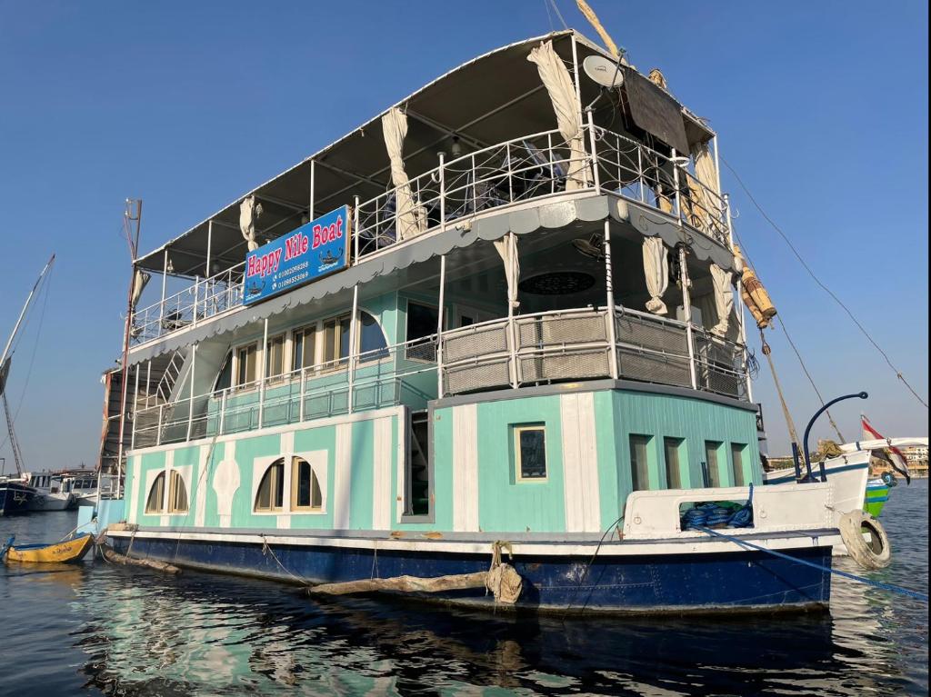 a ferry boat is docked in the water at Floating Hotel- Happy Nile Boat in Luxor