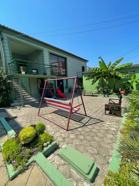 a swing in front of a house at Emilis Vacation Home in K'obulet'i