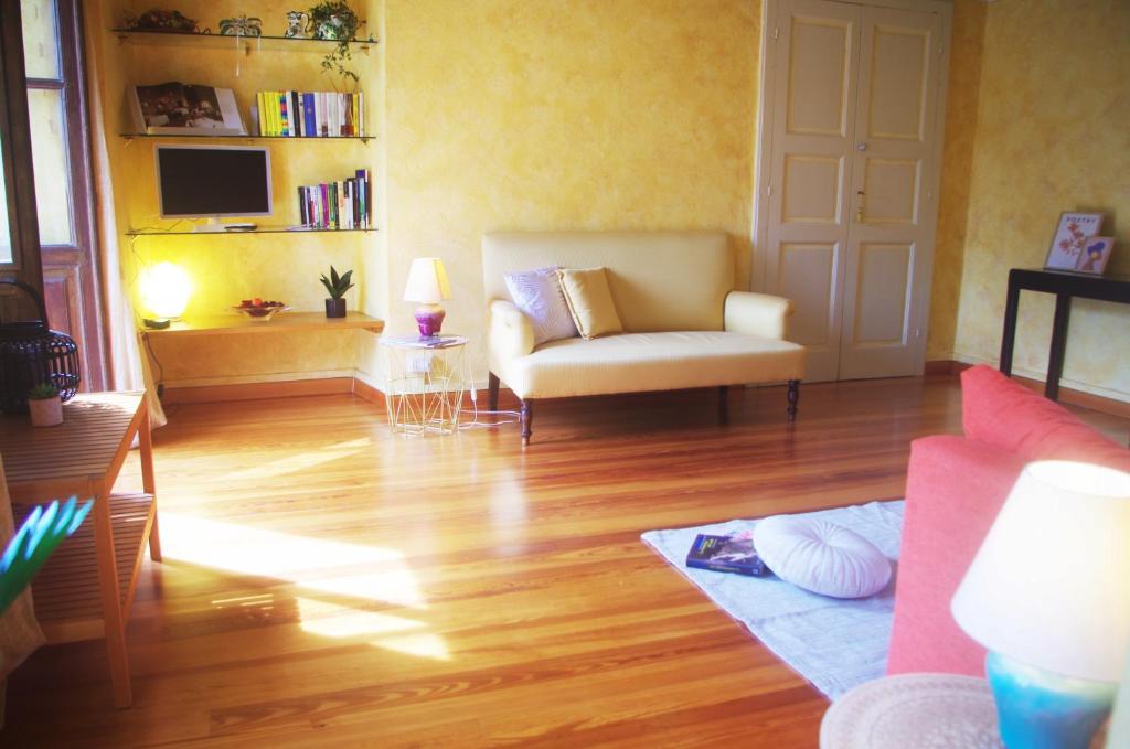 a living room with a couch and a chair at Quick Home - Magnolia in Viverone