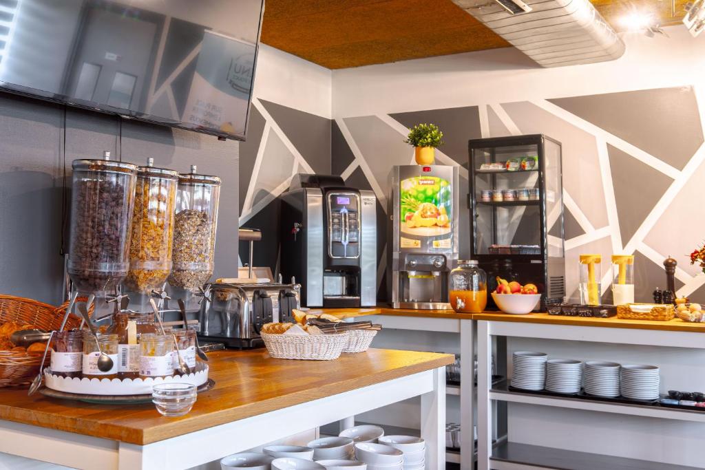 a kitchen with a counter with food and a refrigerator at Zenitude Hôtel-Résidences Nantes Métropole in Nantes