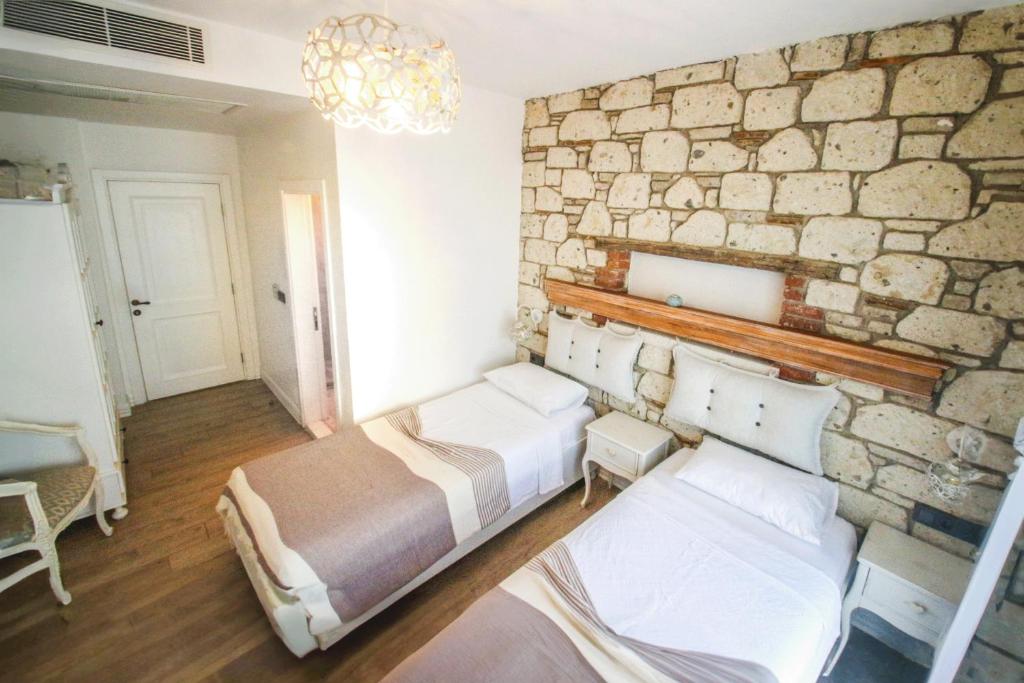 Postel nebo postele na pokoji v ubytování CASA RUBİNO BUTİK OTEL