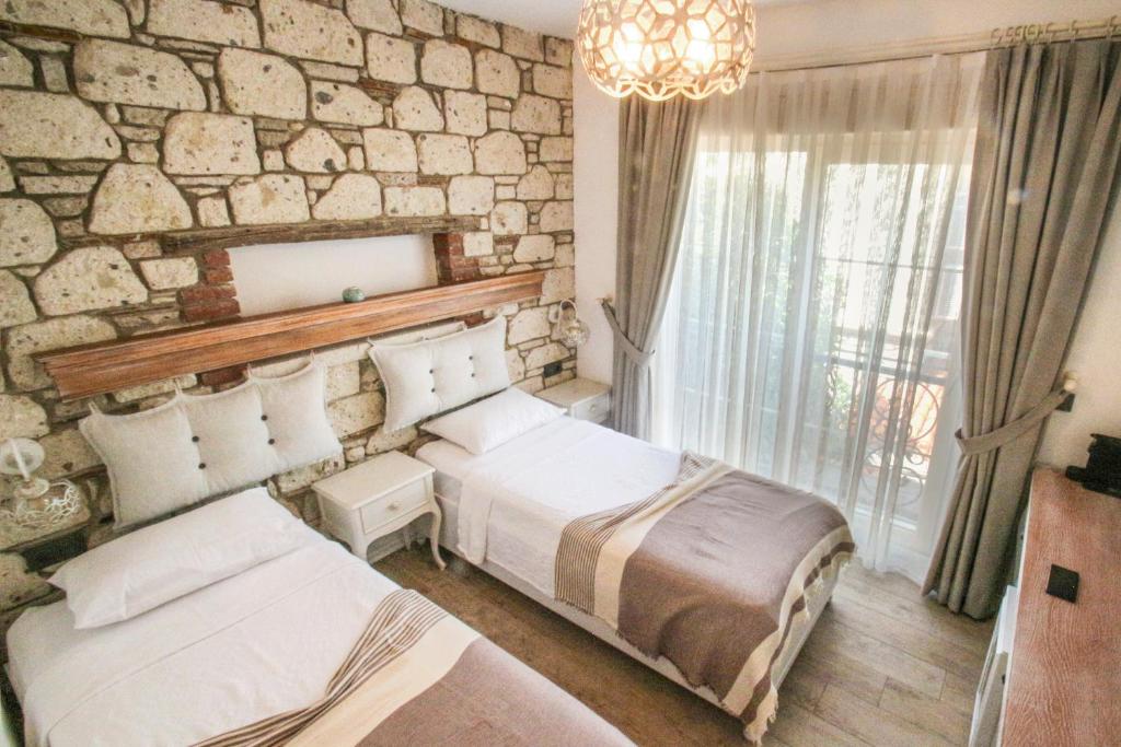 Postel nebo postele na pokoji v ubytování CASA RUBİNO BUTİK OTEL