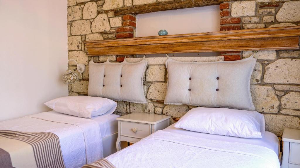 Postel nebo postele na pokoji v ubytování CASA RUBİNO BUTİK OTEL