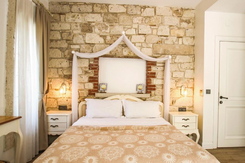Postel nebo postele na pokoji v ubytování CASA RUBİNO BUTİK OTEL