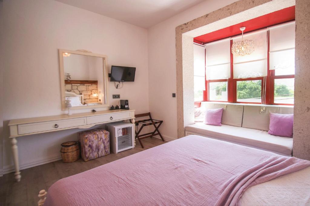 Postel nebo postele na pokoji v ubytování CASA RUBİNO BUTİK OTEL