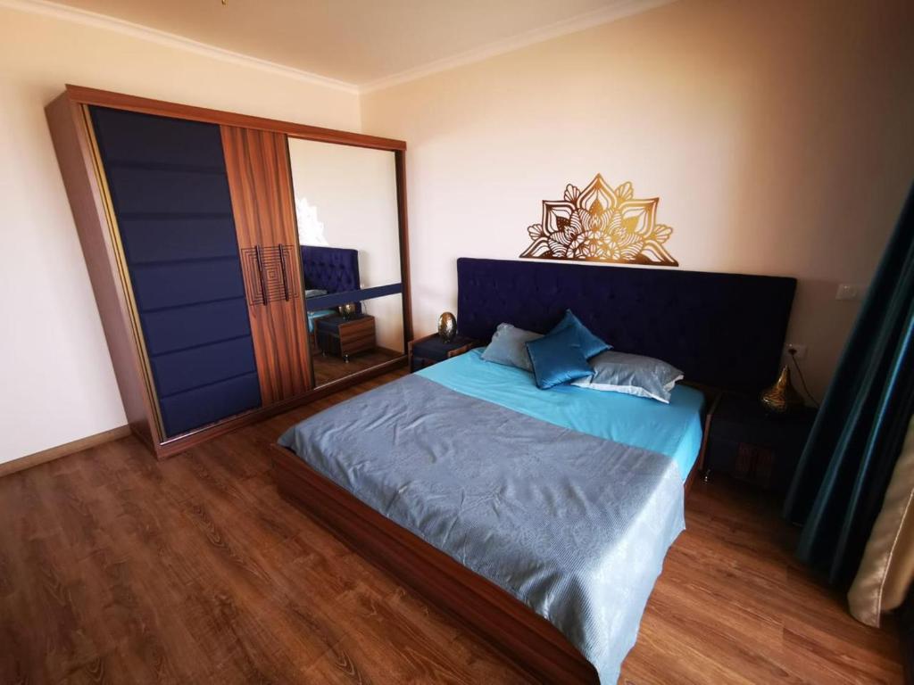 a bedroom with a blue bed with a large window at The View hotel in Hurghada