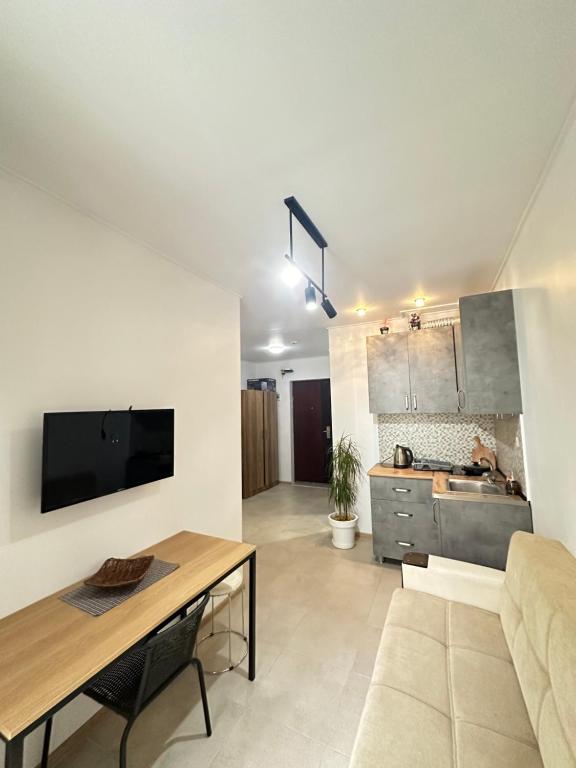 a living room with a couch and a table at Aqua Batumi 47 in Batumi