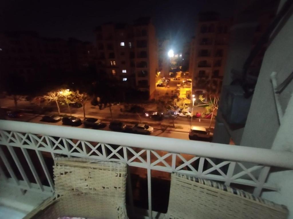 a view of a city at night with cars on a bridge at مدينتى in Madinaty