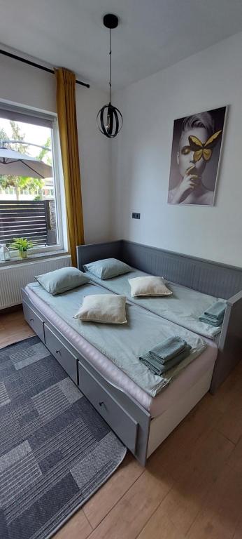 a bedroom with two beds and a window at Apartmani Marinano in Slavonski Brod