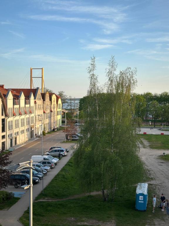 a building with cars parked in a parking lot at Apartament Róża in Giżycko
