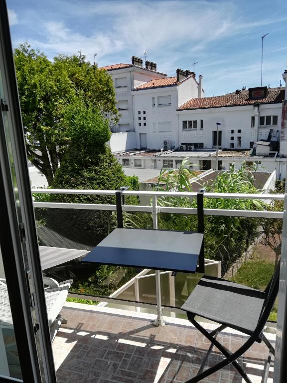 une table bleue et une chaise sur un balcon dans l'établissement Appart royan centre ville plage, à Royan