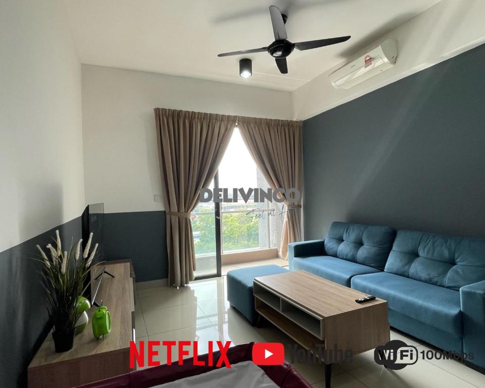 uma sala de estar com um sofá azul e uma janela em Comfy 2 bedroom for 6 pax, 3mins walk to Kamalinda em Shah Alam