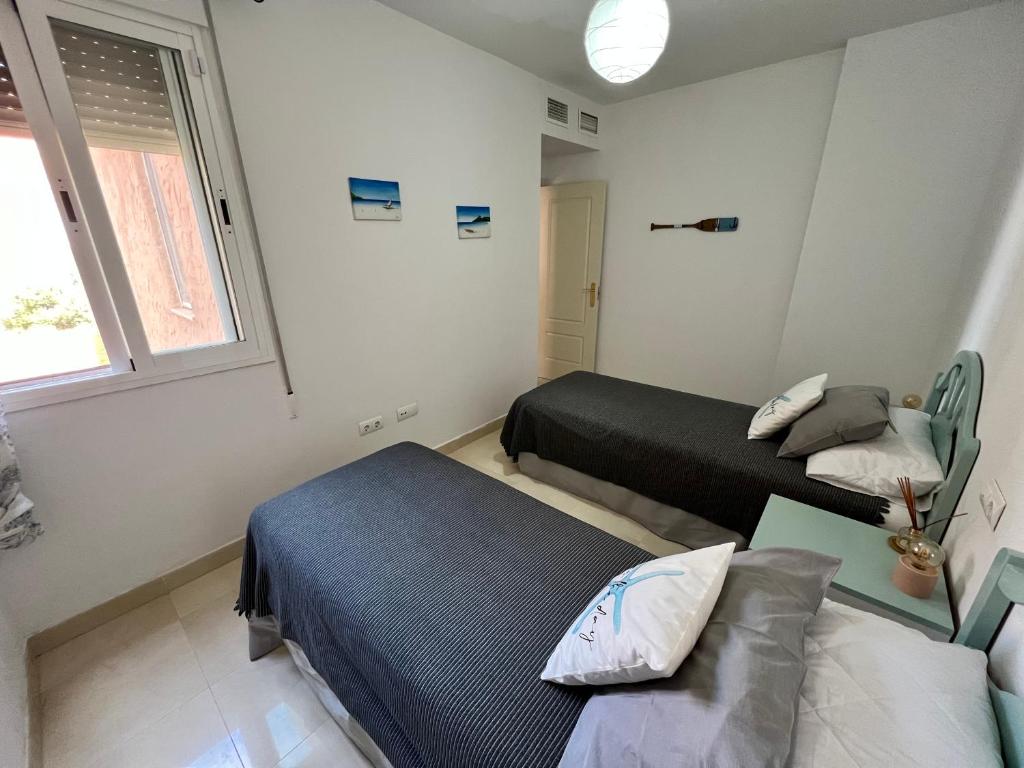 Łóżko lub łóżka w pokoju w obiekcie Mojacar terrazas del Golf