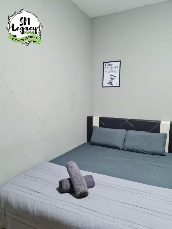 un dormitorio con una cama con un animal de peluche en Hotel SN Legacy en Kuala Terengganu