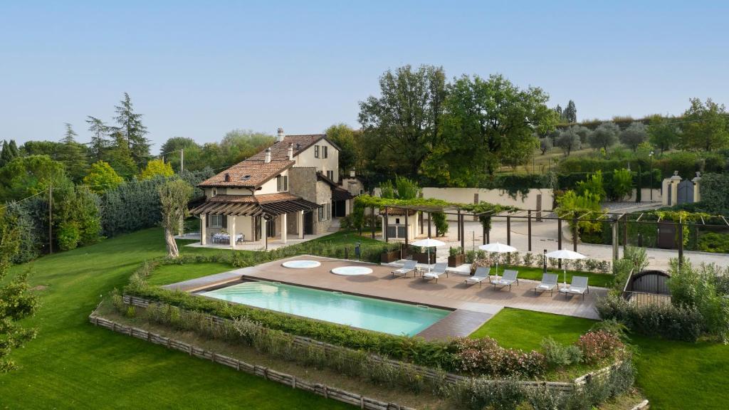 an aerial view of a house with a swimming pool at Villa Pergola by Palazzo di Varignana in Varignana
