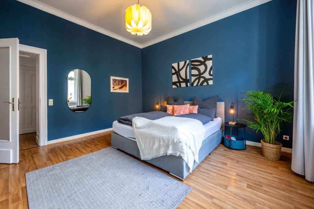 una camera blu con un letto e una parete blu di Südstadt-Oase Komfort mit 2 SZ und Balkon a Coblenza