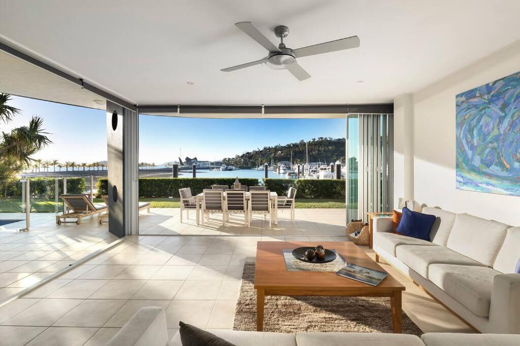 a living room with a couch and a ceiling fan at Pavillions 17 Waterfront with Private Pool and Buggy in Hamilton Island