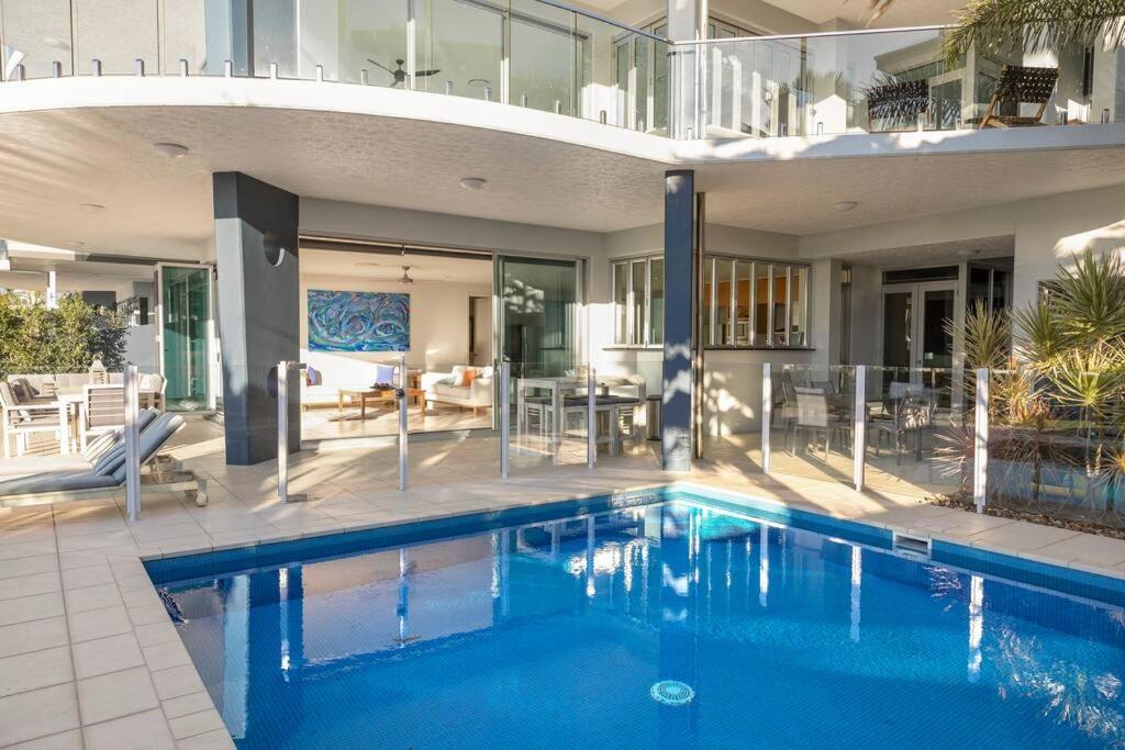 a swimming pool in the middle of a house at Pavillions 17 Waterfront with Private Pool and Buggy in Hamilton Island