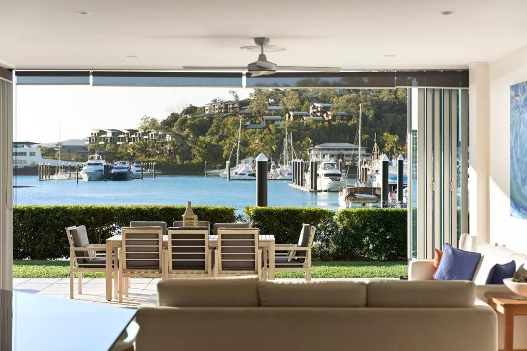 a living room with a couch and a view of a harbor at Pavillions 17 Waterfront with Private Pool and Buggy in Hamilton Island