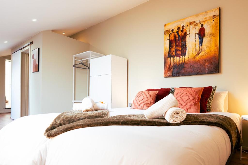 - une chambre avec un lit blanc orné d'une peinture murale dans l'établissement Lets Relax - Terre d'Afrique, à Mons