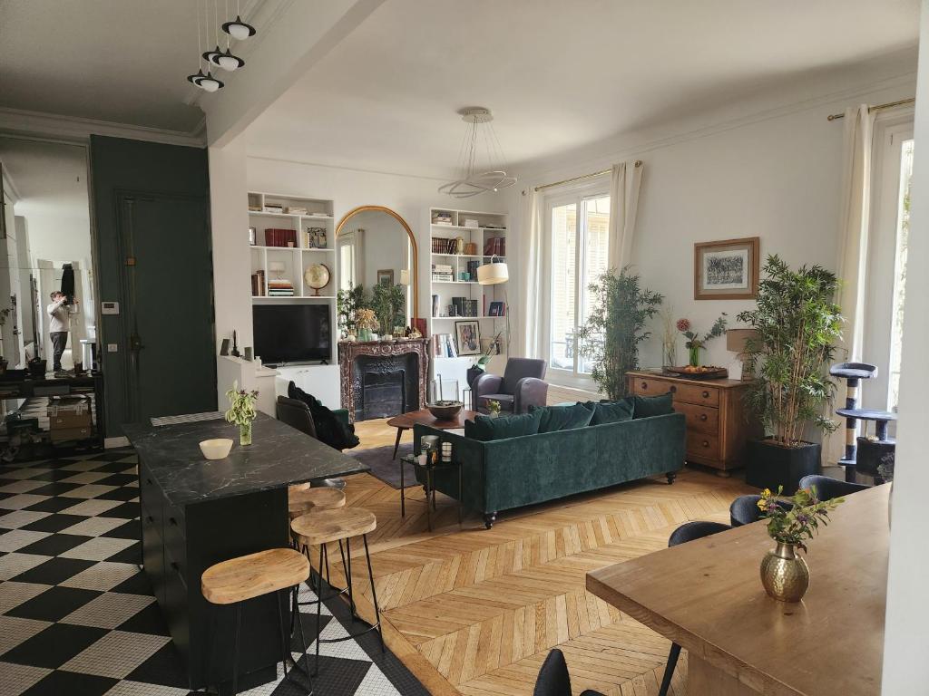 un salon avec un canapé vert et une table dans l'établissement Paris Trocadéro, à Paris