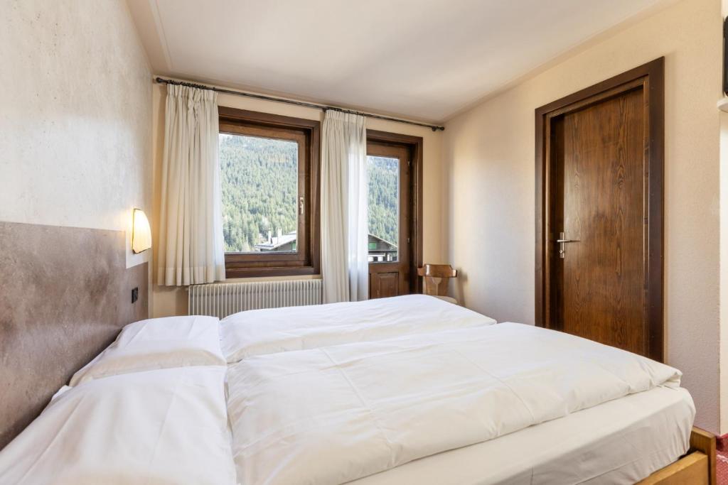 Postel nebo postele na pokoji v ubytování Hotel Cardo