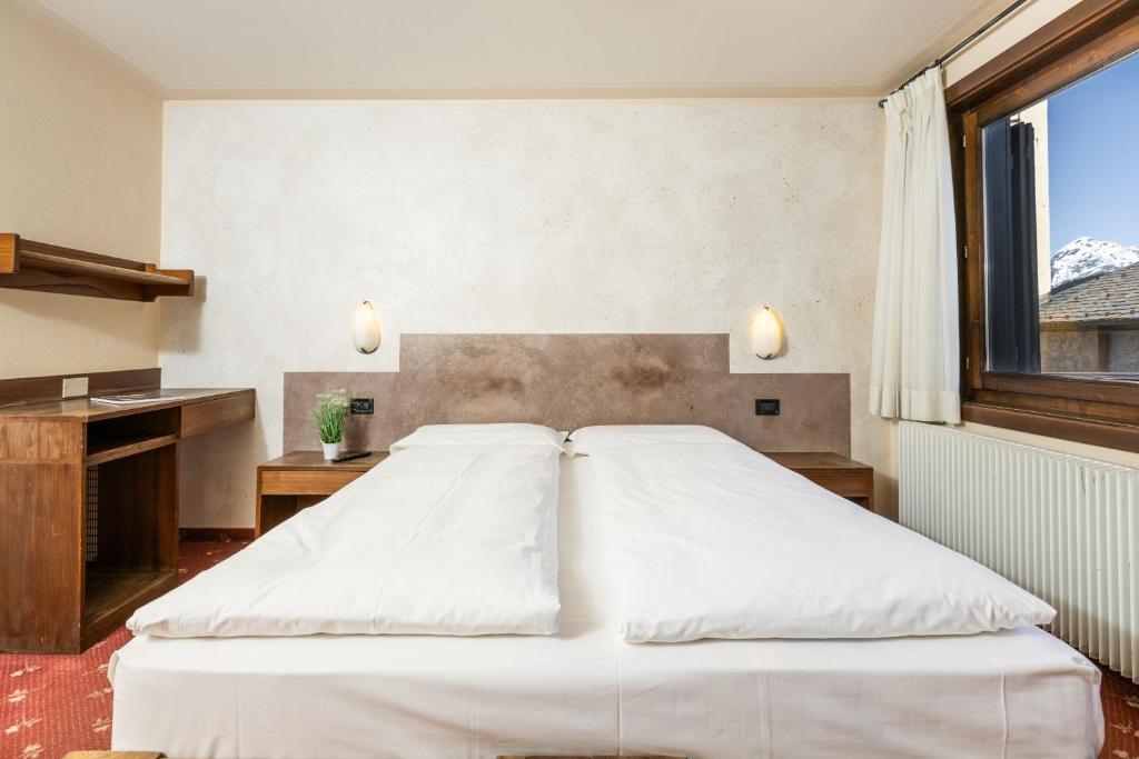 Postel nebo postele na pokoji v ubytování Hotel Cardo