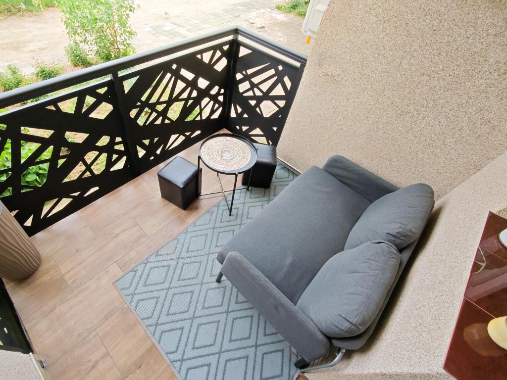a couch sitting on top of a balcony at Apartman Julija in Donji Milanovac