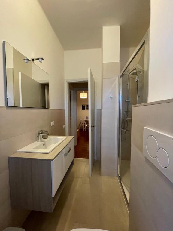 a bathroom with a sink and a shower at La Casa di Simo Appartamento con terrazzo in Salice Terme